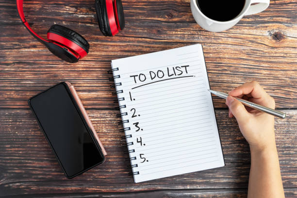 To Do List Text on Note pad on top of desk stock photo