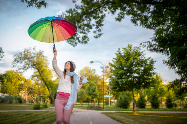 Beautiful girl in the rain with umbrella