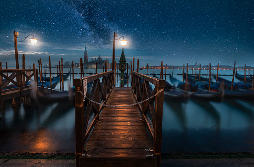 Romantic vacations in Venice, Italy, under starry sky. Dreamlike night scene with beautiful cityscape.