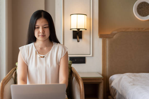 istock Asian woman using laptop computer in a bedroom. 1331631556