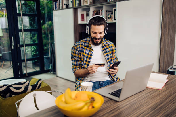 istock Young man enjoying shopping online from his home office 1331634177