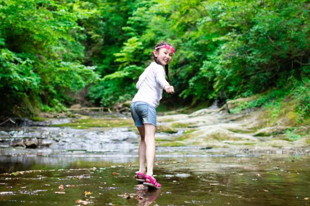 Girl playing in the mountain stream