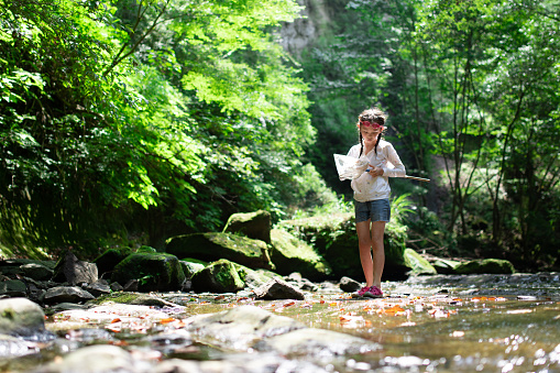 Girl playing in the mountain stream