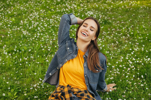 istock Beautiful woman sitting on the grass 1331639014