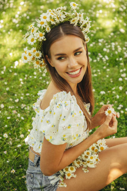 istock Beautiful woman among daisies 1331640258