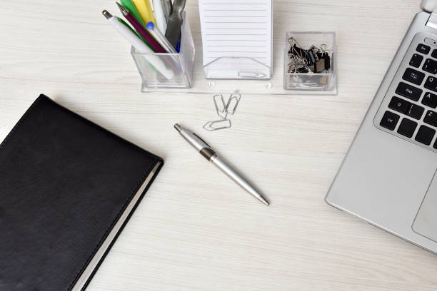 istock agenda with not book and desk stuff on the table. 1331643032