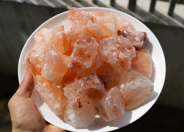 istock Blocks of pink Himalayan salt rock on a white plate 1331643109