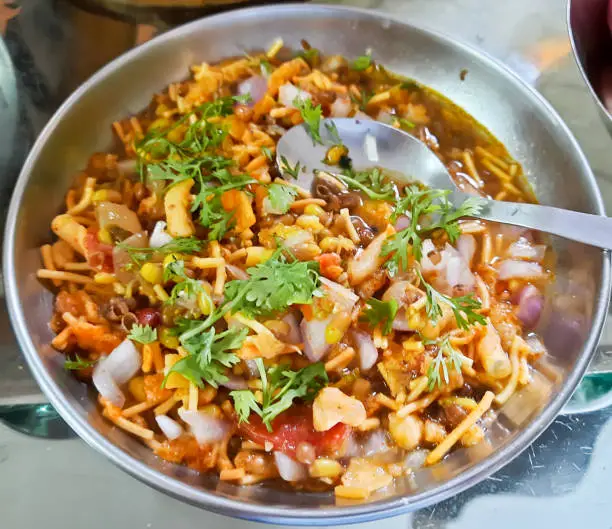 Photo of A popular Indian food item from Maharashtra, called misal pav. Misal pav is a gravy based food item eaten with Indian bread, very popular in Maharashtrian food item.