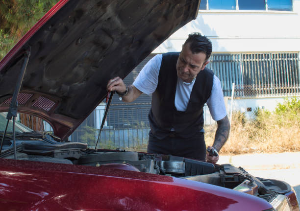 istock mature man repair a breakdown in his car engine with tools 1331649888