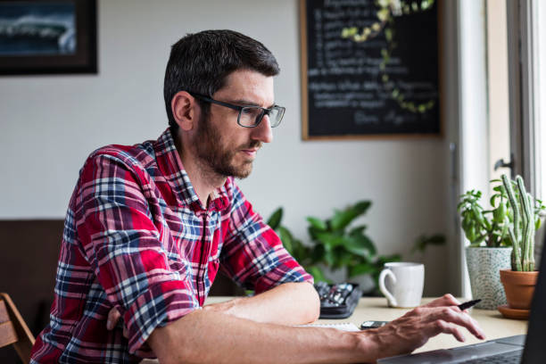 istock Man with glasses working from home 1331649978