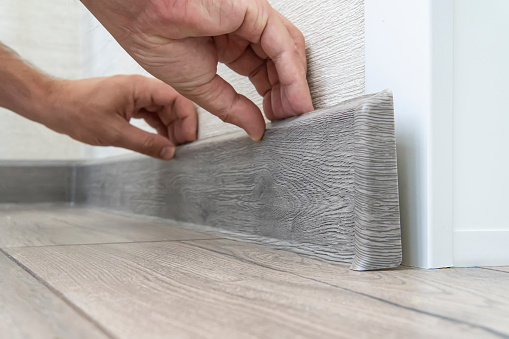 installing the floor skirting board. dismantling of the plastic skirting board.