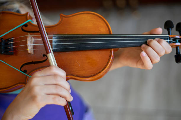 istock little violinist playing the violin top view, horizontal 1331653566