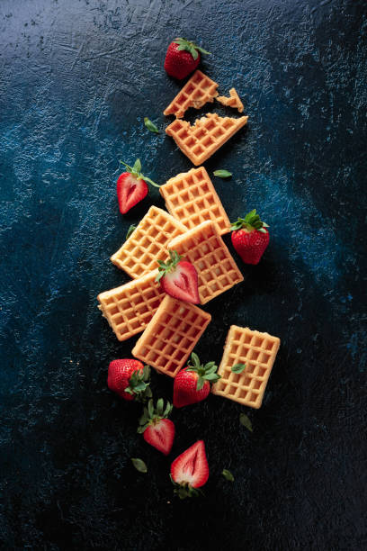istock Waffles with fresh juicy strawberries on a dark blue background. 1331656300