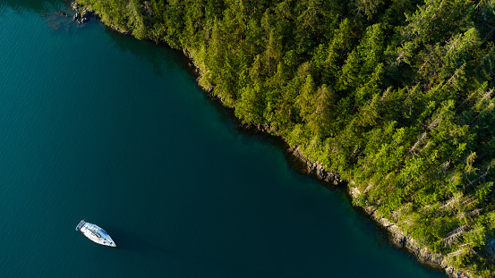 Sailing near Vancouver Canada. Aerial view of a sail boat on a coastline. Sailing backgrounds.