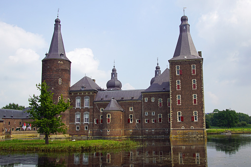 In Muiden, Netherlands Muiderslot, a Medieval Castle stands surrounded by a moat of water on a winter day.