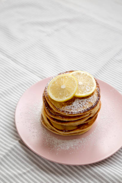istock Homemade Lemon Ricotta Pancakes on a pink plate, low angle view. Copy space. 1331669708