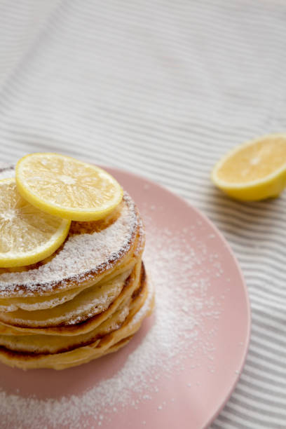 istock Homemade Lemon Ricotta Pancakes on a pink plate, side view.  Copy space. 1331670373