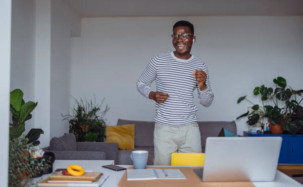 Excited Young Man Dancing and Singing at Home