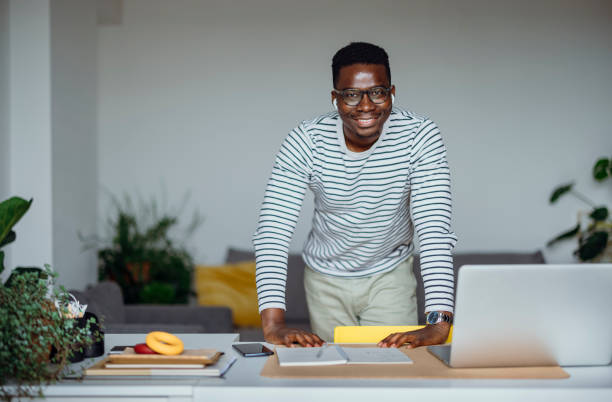 istock Cheerful Businessman Working At Home and Looking at Camera 1331670578