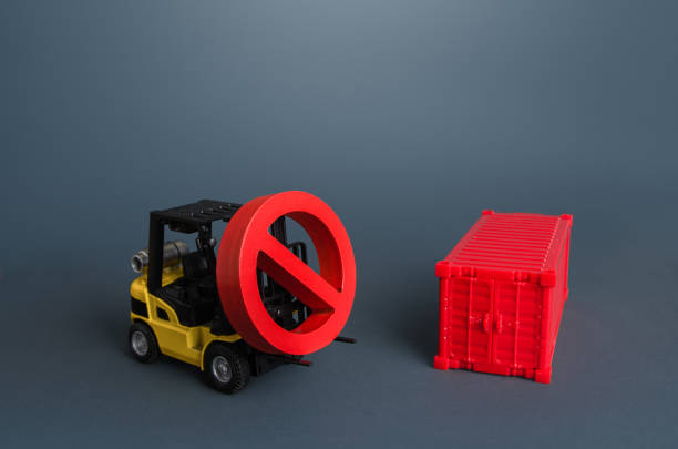 istock A forklift carries a no sign and a shipping container. Global container shortage. Logistics problems. Restrictions on import and export. Ban on transfer of goods, trade wars. Sanctions, Limiting 1331671622