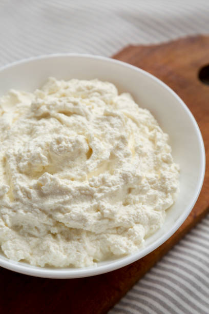istock Tasty Ricotta Cheese in a White Bowl, side view. Close-up. 1331672163