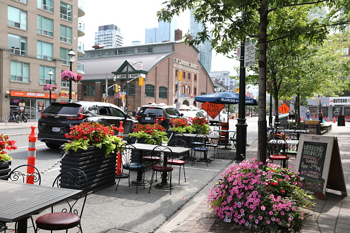 July 16, 2021 - Toronto, Ontario, Canada: Cafe with patio on Front Street near St. Lawrence Market Toronto during Stage 3 of Covid-19 reopening plan in July 2021. Front Street of Toronto. Sightseeing Toronto. Travelling in Ontario. Ontario must see places. Canadian heritage. People finally dining in Toronto after some Covid-19 restrictions lifted.