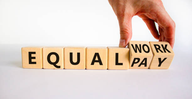 istock Equal pay and work symbol. Businessman turns wooden cubes and changes words equal pay to equal work. Beautiful white background. Copy space. Business and equal pay and work concept. 1331672323