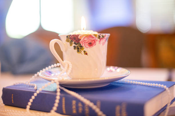istock Tea cup and plate with hand painted roses draped in pearls on a blue bible2 1331672361
