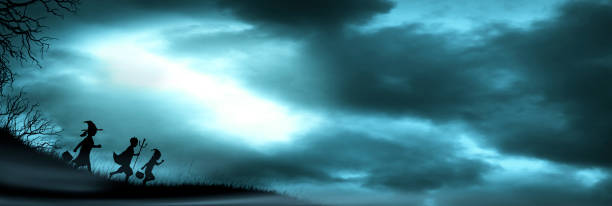 istock Three Children Dressed Up For Halloween Silhouetted Against Moonlit Clouds 1331673383