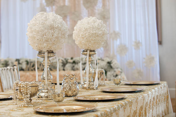 istock Gold table centerpieces with white ball flowers with diamonds 1331678095