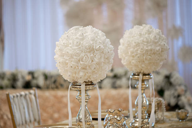 istock Gold table centerpieces with white ball flowers with diamonds 1331678402