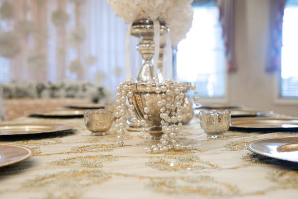 Gold table centerpieces with white ball flowers with diamonds