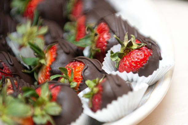 istock Delicious chocolate covered stawberries on white dish at desert bar 1331679362