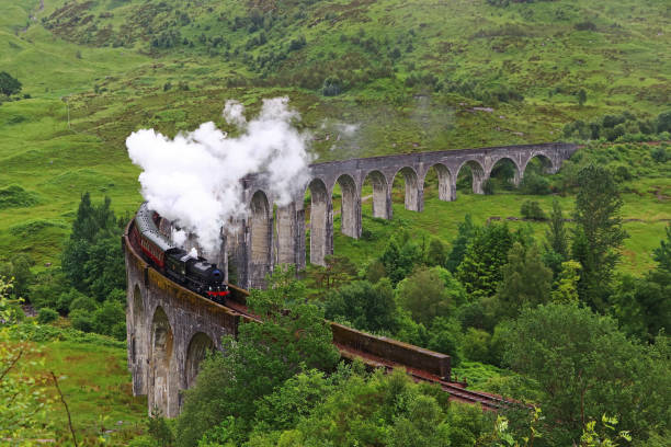 The steam locomotive on the famous Glenfinnan Viaduct in Scotland The steam locomotive on the famous Glenfinnan Viaduct in Scotland fort william stock pictures, royalty-free photos & images