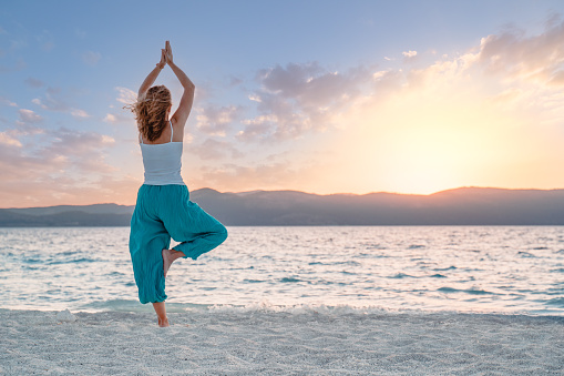 Beautiful woman is meditating ,doing yoga in Lake Salda