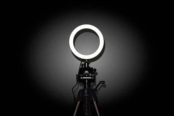 istock LED ring lamp with adjustable brightness for a studio camera, photo phone, video lamp with tripods. Vector stock illustration eps10. 1331682840