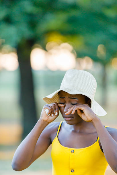 beautiful african-american woman is having allergy problems outside in nature. - human eye eyesight women creativity imagens e fotografias de stock