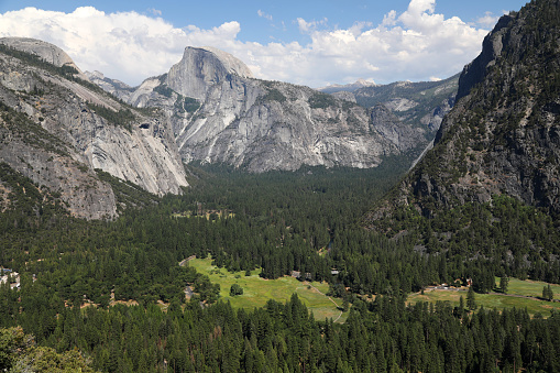 Person overlooking vast mountains of Yosemite National Park from Half Dome