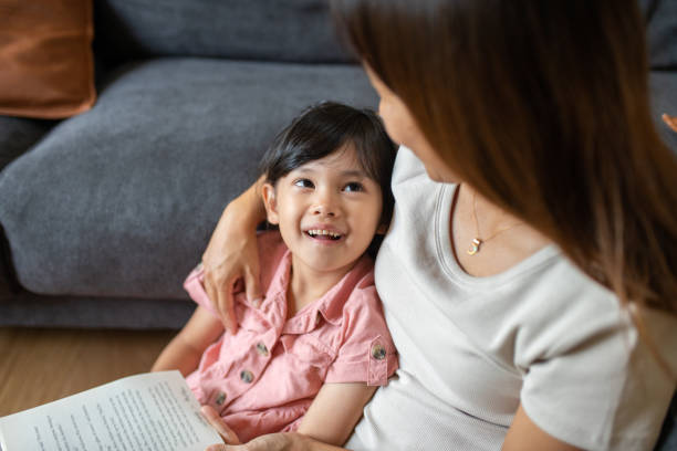 istock Mother reading to her daughter 1331689706