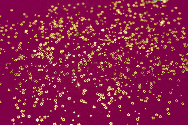 istock Gold glitter stars on a purple background 1331692420