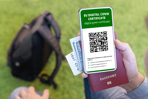 vaccinated person using digital health passport app in mobile phone for travel during covid-19 pandemic. green certificate. Certificate for confirming vaccination and the presence of antibodies