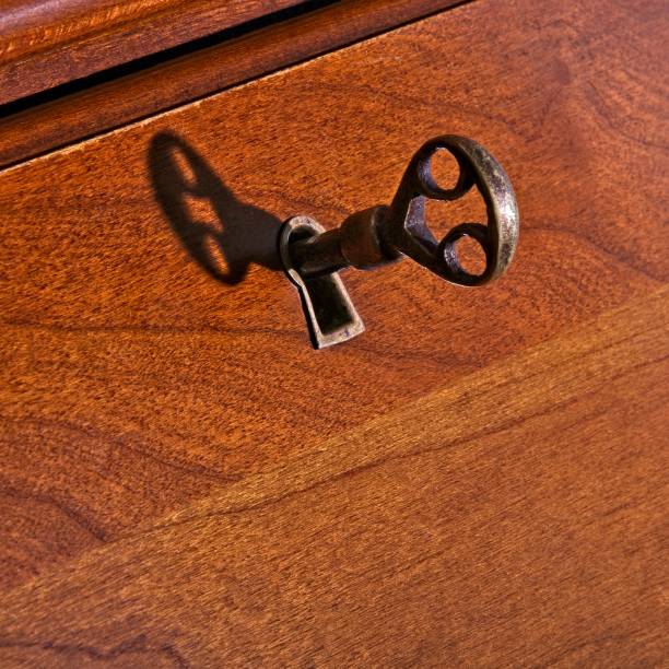 istock Antique desk key in lock with shadow 1331702864