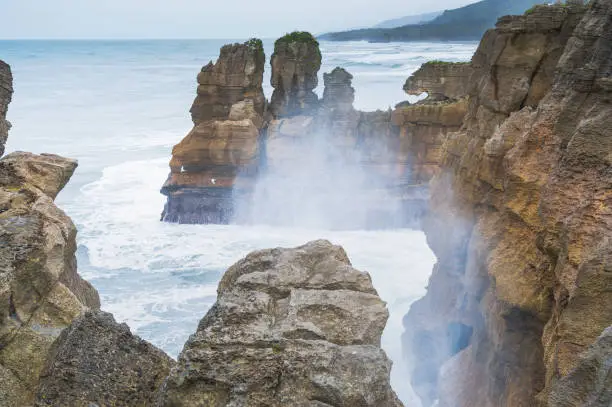A wide-view shot Pancake Rocks in coastline and beach sea in Punakaiki, South Island, New Zealand.