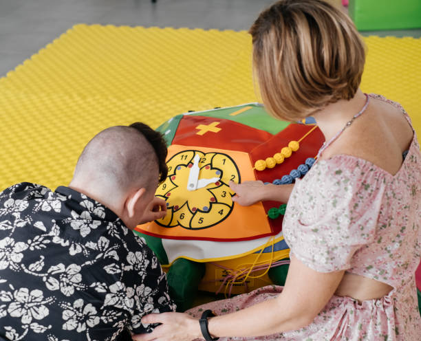 istock disabled child doing sensory activity with toys, rehabilitation 1331713728