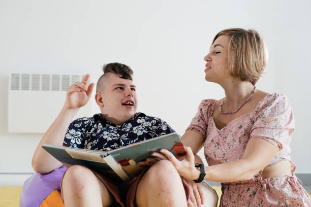 disabled child reading book, communicating, rehabilitation