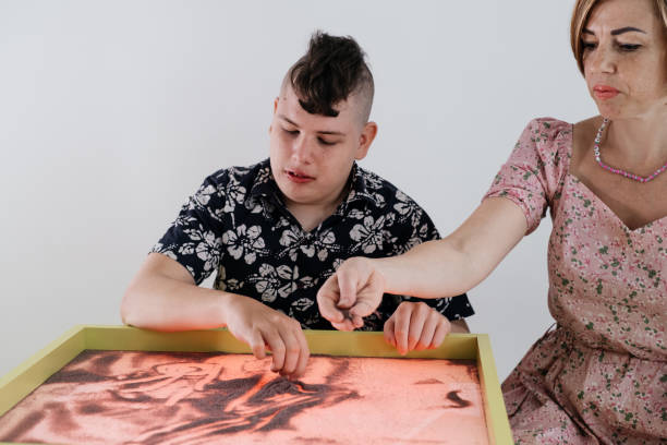 istock disabled child doing sensory activity with sand, rehabilitation 1331713823