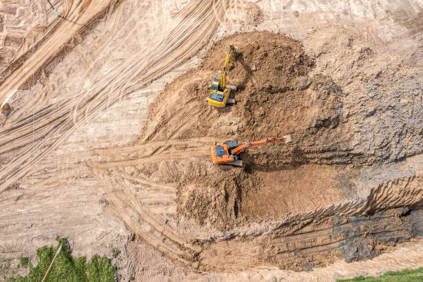 istock two excavators working at construction site on earthworks. heavy construction machinery. aerial view. 1331717752