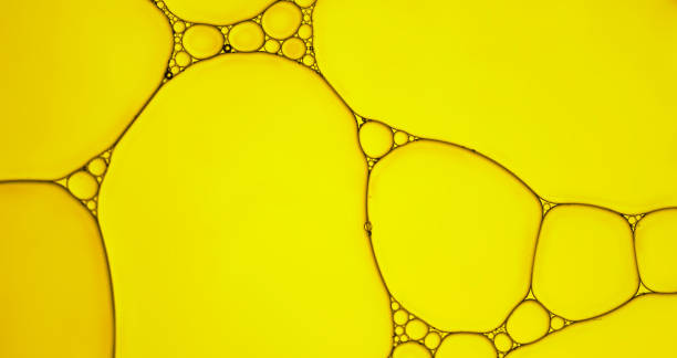istock Abstract  of oil droplets patterns creating an art image with shadow effect caused by lighting and colour on golden-yellow coloured background. 1331722247