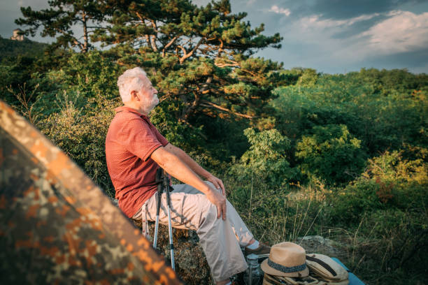 Senior people meditating in nature.