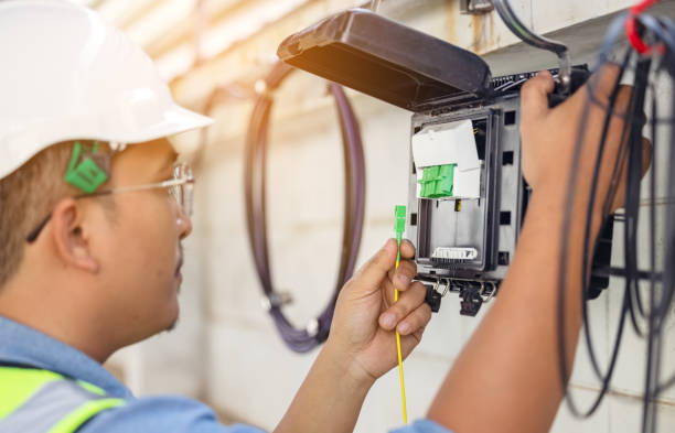 istock An internet technician is repairing or maintaining a fiber optic connection by opening a fiber optic connector. 1331730476